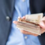 Businessman Hand Holding Thai Baht Banknote Stack_
